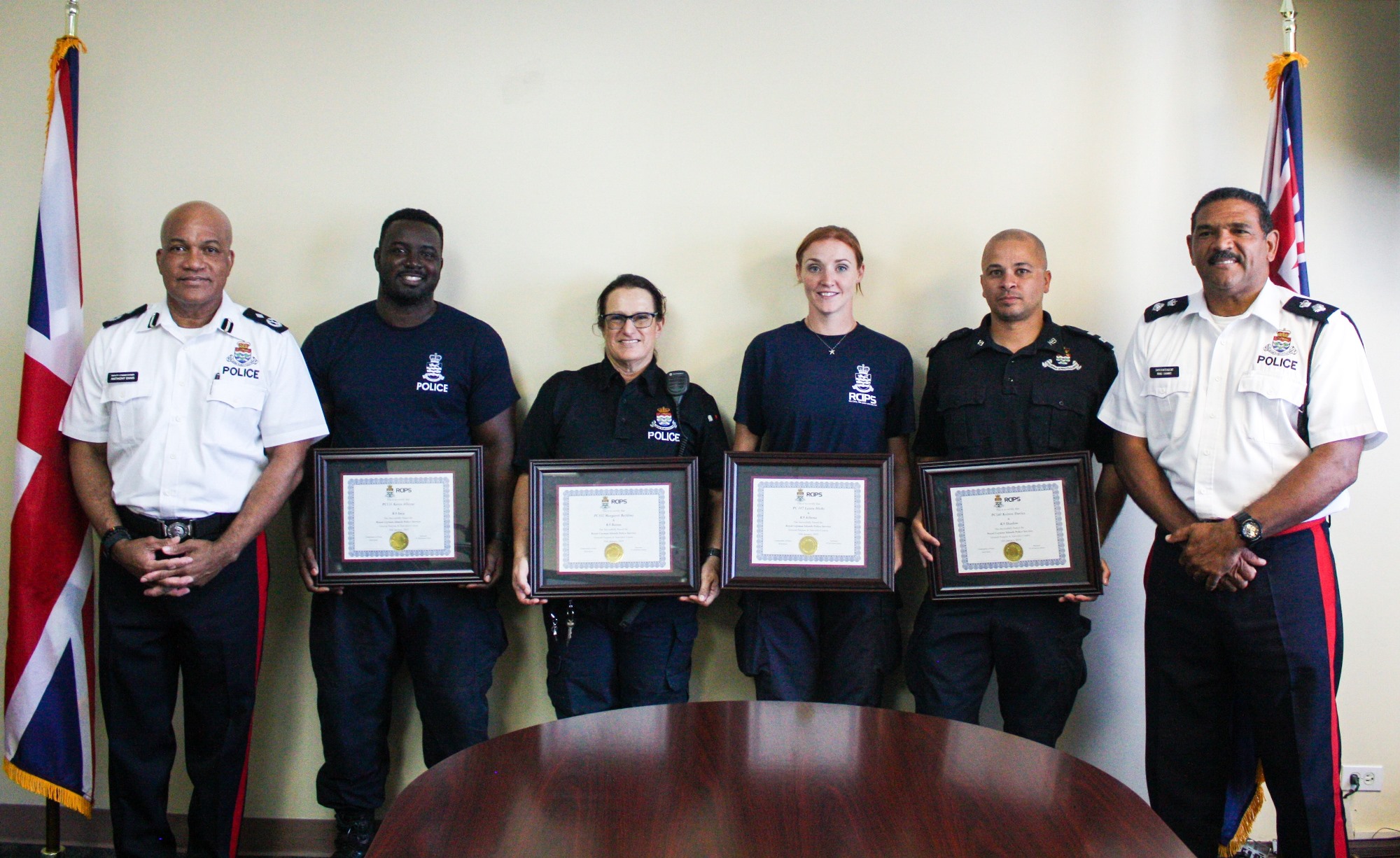 The K-9 officers are presented their certificates by Deputy Commissioner Ennis and A/Superintendent Brad Ebanks