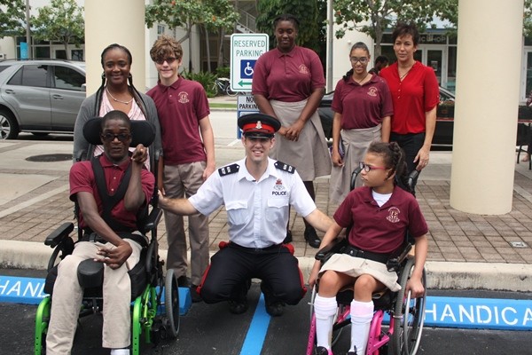 Seven Mile Beach Community Officer Spearheads Disabled Parking Sign Initiative at Camana Bay, 23 May