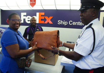 RCIPS and FedEx Assist Local Taxi Operator in Reuniting a Visitor with her Lost Handbag